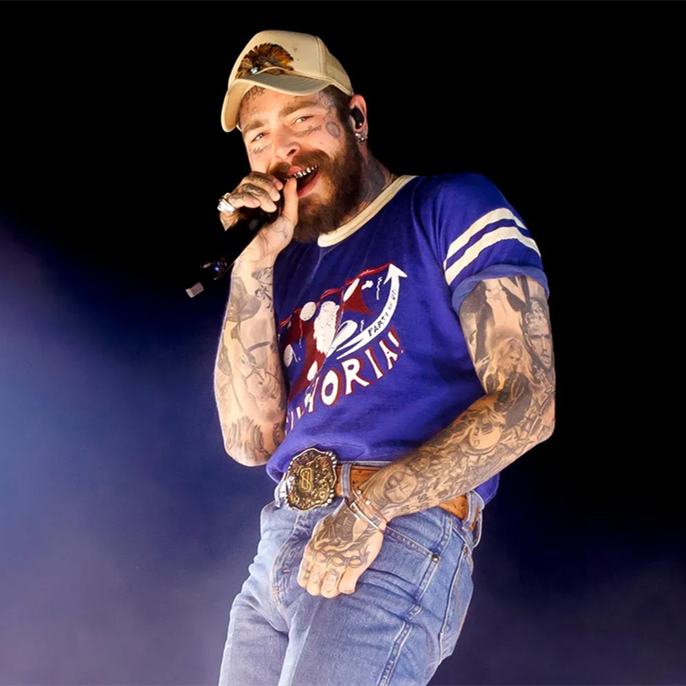 Post Malone falls off concert stage while reaching out to toast a fan